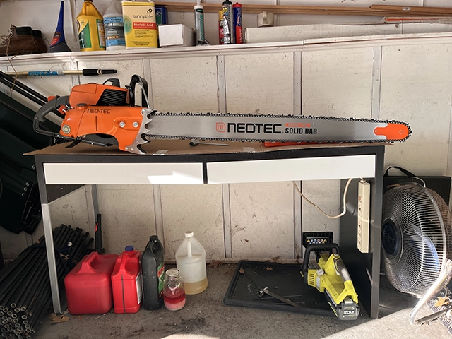 A chainsaw with a 42 inch bar in a garage.