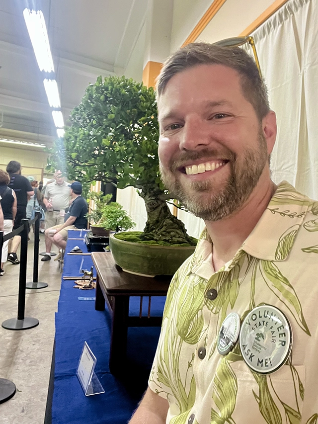 Shawn Cagle volunteering at the Minnesota Bonsai Society State Fair Exhibit.