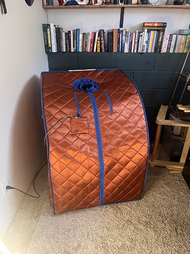 Infrared sauna tent in a basement office.